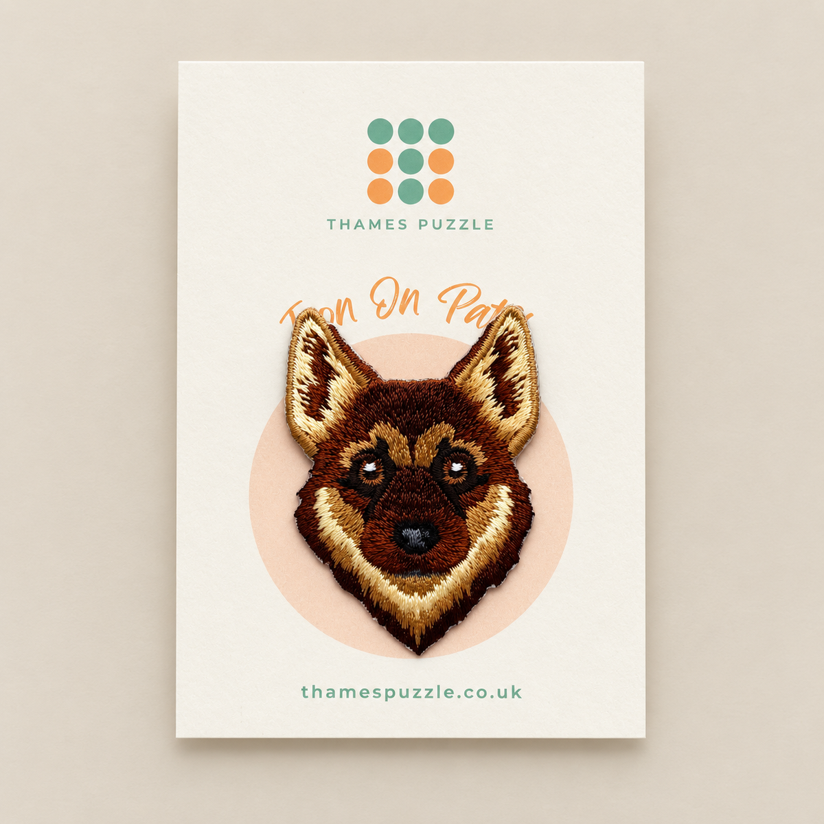 A product card for 'Iron On Patch' by Thames Puzzle, featuring a detailed embroidered German Shepherd dog head patch on a cream background with the brand logo and website.